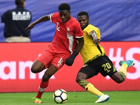 Canada's Alphonso Davies (L) and Jamaica's Kemar Lawrence (R) fighting for the ball during their CONCACAF tournament quarterfinal match at the University of Phoenix Stadium in Glendale, Arizona on July 20, 2017.