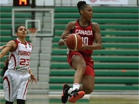 Team Canada's Nirra Fields (right) takes to the air as she eludes Team Turkey's Merve Aydin (left) during game action in the first game of the 2018 Edmonton Grads International Classic basketball tournament held at the Saville Community Sports Centre in Edmonton on Wednesday, July 4, 2018.
