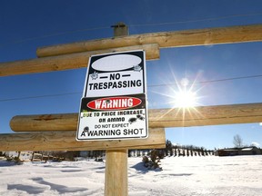 A warning sign is posted on a fence at the entrance to a rural property north of Okotoks.. Jim Wells/Postmedia