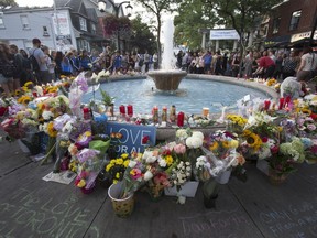 Flower along a fountain during a vigil at Alexander the Great Parkette along the Danforth at Logan Ave. in Toronto, Ont. on Wednesday July 25, 2018.