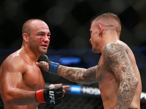 Eddie Alvez, left, is consoled by Dustin Poirier in a lightweight main event bout during UFC Fight Night at the Saddledome in Calgary on Saturday, July 28, 2018. (Jim Wells/Postmedia Network)