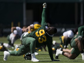 Kwaku Boateng (93) stretches during Edmonton Eskimos practice on Saturday, July 21, 2018 in Edmonton.