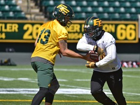 C.J. Gable (2) takes a hand-off from quarterback Mike Reilly during the Eskimos practice as they prepare to face Toronto Friday at Commonwealth Stadium in Edmonton, July 12, 2018.