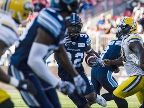 Toronto Argonauts running back James Wilder Jr. (32) evades the defensive line of the Edmonton Eskimos fourth quarter CFL action in Toronto on Saturday, July 7, 2018.