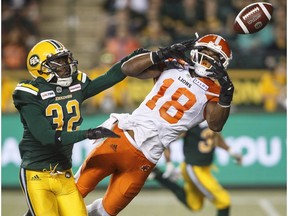 B.C. Lions Cory Watson (18) misses the catch as Edmonton Eskimos Nicholas Taylor (32) tries to defend during second half CFL action in Edmonton on Friday June 29, 2018.