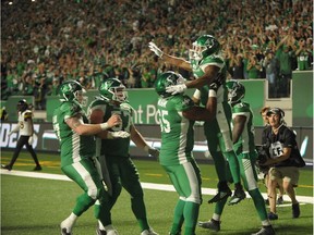 Saskatchewan Roughriders running back Marcus Thigpen is hoisted by his teammates after scoring the game-winning touchdown Thursday against the visiting Hamilton Tiger-Cats.