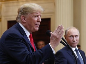 U.S. President Donald Trump speaks with Russian President Vladimir Putin during a press conference after their meeting at the Presidential Palace in Helsinki, Finland, Monday, July 16, 2018.