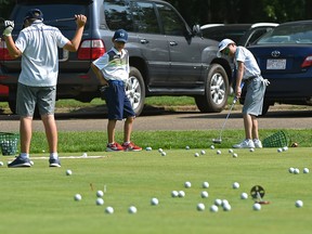 Golf balls litter the green as practice makes prefect for these junior golfers during a clinic on the practice green at the Victoria Golf Club in Edmonton, July 29, 2018.