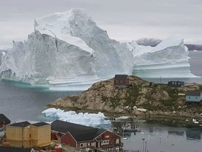 In this Thursday, July 12, 2018 photo, a view of an Iceberg, near the village Innarsuit, on the northwestern Greenlandic coast.