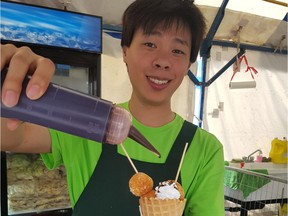 At Taste of Edmonton,  Kevin Kao prepares the Loma House sweet potato balls dessert. (GRAHAM HICKS/EDMONTON SUN)