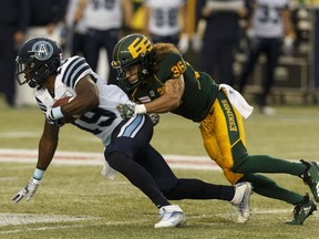 Edmonton Eskimos' Aaron Grymes (36) tackles Toronto Argonauts' S.J. Green (19) during a CFL football game at Commonwealth Stadium in Edmonton, on Friday, July 13, 2018. Photo by Ian Kucerak/Postmedia Photos for copy in Saturday, July 14 edition.