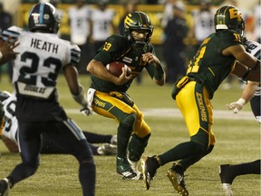 Edmonton Eskimos quarterback Mike Reilly (13) runs the ball against the Toronto Argonauts defence on July 13, 2018, during the second half of CFL action at Commonwealth Stadium in Edmonton.