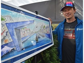 Simon Whitfield, retired Olympic triathlon champion, poses next to an artist rendering at the ITU World Triathlon, of the World Triathlon Championship in 2020 at Hawrelak Park in Edmonton, July 27, 2018.