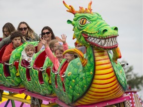 Families enjoying the roller coaster ride during Monday Morning Magic at K-Days. (Shaughn Butts/Postmedia)