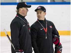 Head Coach Ken Babey, left, and assistant coach Luke Pierce talk as Canada's sledge hockey team practices ahead of the start of competition at the Gangneung practice venue during the 2018 Winter Paralympic Games in Pyeongchang, South Korea, on March 8, 2018.