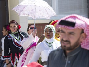 Students line up for the fashion show wearing their traditional clothing.Metro Continuing Education hosted DiversiTEA their annual cultural celebration featuring tea and treats from around the world. The students held a multicultural fashion show, complete with world music on July 6, 2018. Shaughn Butts / Postmedia For a Dustin Cook story running July 7, 2018.