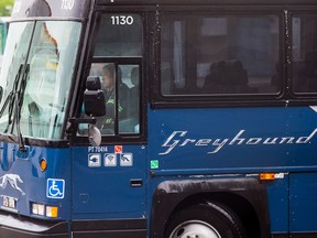 A worker moves a Greyhound bus after it was washed, in Vancouver, on Monday July 9, 2018.