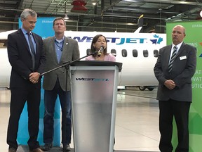 Emissions Reduction Alberta CEO Steve MacDonald, WestJet vice-president Mike McNaney, Environment Minister Shannon Phillips and Calgary city councillor Peter Demong attend a press conference in Calgary on July 18, 2018, announcing up to $70 million in funding for clean technology programs.