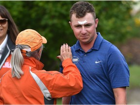 Alistair Docherty from Washington, gets some consoling by a voluteer after getting stung at least eight times by wasps going into the trees after his ball during the first round of Oil Country Championship at the Edmonton Petroleum Golf Club, August 2, 2018.