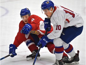 Edmonton Oil Kings Jacson Alexander, left, gets down low against Brian Harris (10) in the annual Red and White intrasquad game during training camp at the Downtown Community Arena in Edmonton, August 29, 2018.