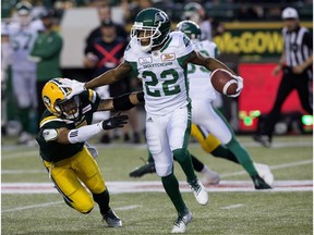 Edmonton Eskimos' Josh Woodman (7) chases the Saskatchewan Roughriders' Christion Jones (22) during first half CFL action at Commonwealth Stadium, in Edmonton Thursday Aug. 2, 2018.