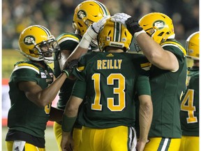 Edmonton Eskimos celebrate Mike Reilly's (13) game winning touchdown against the Saskatchewan Roughriders during second half CFL action at Commonwealth Stadium, in Edmonton Thursday Aug. 2, 2018. The Eskimos won 26 to 19.