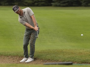 Tyler McCumber takes a shot from a bunker on the 9th hole during the third round of the Syncrude Oil Country Championships at the Edmonton Petroleum Golf Club, in Edmonton Saturday Aug. 4, 2018. Photo by David Bloom