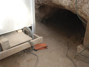 An exit tunnel is seen within a squalid makeshift living compound in Amalia, N.M., on Friday, Aug. 10, 2018, where five adults were arrested on child abuse charges and remains of a boy were found. (AP Photo/Morgan Lee)