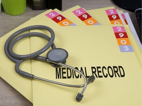 Medical record folders and stethoscope on working desk.