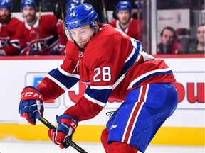 Jakub Jerabek of the Montreal Canadiens skates the puck against Curtis Lazar of the Calgary Flames during NHL action at the Bell Centre on Dec. 7, 2017 in Montreal.