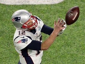 In this Feb. 4 file photo, New England Patriots quarterback Tom Brady drops a pass from tight end Rob Gronkowski against the Philadelphia Eagles in the Super Bowl.