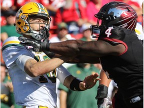 Calgary Stampeder Micah Johnson goes after Edmonton Eskimos quarterback Mike Reilly during the second half of the Labour Day Classic at McMahon Stadium, Monday September 4, 2017.