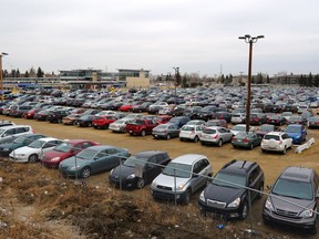 Cars and trucks fill the park and ride at the Century Park Transit Station.