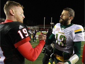 Stamps QB Bo Levi Mitchell, left, and Eskimos QB Mike reilly shake hands following the CFL Western Final in Calgary between the Calgary Stampeders and the Edmonton Eskimos on Sunday, November 19, 2017.