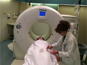 Technologist Birdie Letendre demonstrates the use of a CT scanner on patient Melissa Shiach at the Grey Nuns Community Hospital in Edmonton on March 6, 2017.