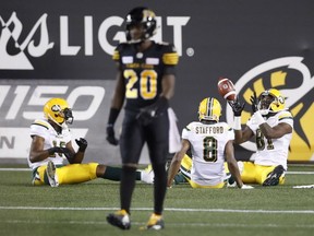 Edmonton Eskimos' D'haquille Williams, right, celebrates his touchdown with teammates Kenny Stafford, and Vidal Hazelton, as Hamilton Tiger-Cats' Mariel Cooper walks away during the first half of CFL football action in Hamilton on Aug. 23, 2018.