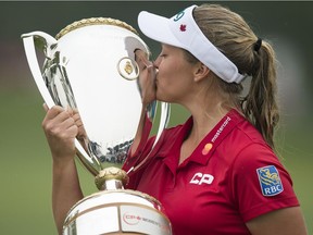 Canada's Brooke Henderson kisses the trophy after winning the CP Women's Open on Sunday at the Wascana Country Club.