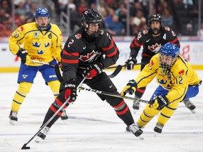 Canada's Justin Barron (2) is pursued by Sweden's Karl Henriksson (20) and Arvid Costmar (12) during first period Hlinka Gretzky Cup gold medal game action in Edmonton on Saturday, August 11, 2018.