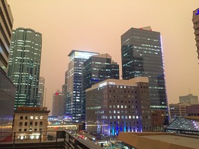 The sky above the Edmonton skyline turned a dark, yet bright orange Wednesday morning as smoke from the B.C. wildfires blanketed the city on August 15, 2018.