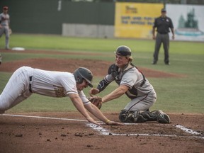 Michael Gahan of the Edmonton Prospects is tagged out at home plate by catcher Reed Odland of the Medicine Hat Mavericks at Re/Max field in Edmonton on August 7, 2018. Game 3 of WMBL playoff series best of five.