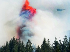 Helicopters and water bombers fight a wildfire along Highway 99 north of Horseshoe Bay in West Vancouver, BC., August 9, 2018.
