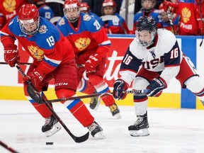 Russia's Vasili Podkolzin (19) is pursued by USA's Michael Mancinelli (16) during first period Hlinka Gretzky Cup bronze medal game action in Edmonton on Saturday, August 11, 2018.