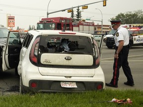 Police investigate a shooting incident and police chase that ended on 75 Street near 101 Avenue on Wednesday Aug. 15, 2018. The suspect vehicle was a white Kia Soul. Three occupants of the suspect vehicle were arrested and the driver was taken to hospital by ambulance.