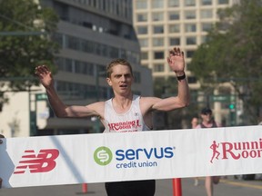 Lucas McAneney won the Edmonton Marathon in a time of 2:26:14 and finished on Jasper Avenue in front of the Shaw Conference Centre on August 19, 2018.