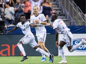 Vancouver Whitecaps' Alphonso Davies, from left to right, Brek Shea and Kei Kamara celebrate Davies' second goal against Minnesota United during the second half of an MLS soccer game in Vancouver, on Saturday July 28, 2018.