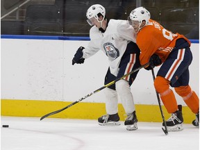 Kailer Yamamoto battles Caleb Jones (in orange) during the Edmonton Oilers rookie camp at Rogers Place, in Edmonton Monday Sept. 10, 2018.