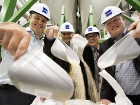 Ostara chief technology officer Ahren Britton, left, Alberta Environment assistant deputy minister John Conrad, Edmonton city Coun. Aaron Paquette, and Epcor president and CEO Stuart Lee pour out fertilizer pellets during a tour of the new nutrient recovery facility at the Edmonton Waste Management Centre on Wednesday, Sept. 12, 2018. The facility removes phosphorus and other nutrients from wastewater and turns it into fertilizer.