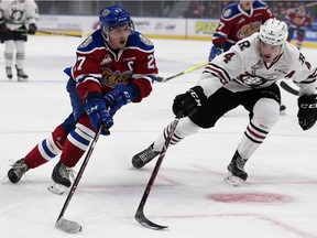 The Edmonton Oil Kings winger Trey Fix-Wolansky (27) battles the Red Deer Rebels defenceman Alexander Alexeyev (4) during first period WHL action at Rogers Place, in Edmonton Friday Sept. 21, 2018.