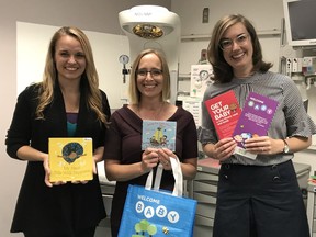 Deanna Ganske, left, a Stollery Children’s Hospital neonatal intensive care unit (NICU) parent volunteer, Dr. Amber Reichert, a NICU neonatologist at the Stollery, and Tamsin Shute, a youth services librarian at Edmonton Public Library, are celebrating the expansion of the library's Welcome Baby program, which provides NICU parents a package that includes a book bag, board book, compact disc of downloadable songs and rhymes, early literacy information and an invitation to get a free library card.