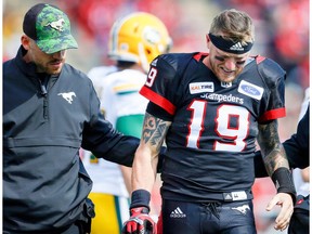 Calgary Stampeders quarterback Bo Levi Mitchell is helped off the field after suffering leg injury against the Edmonton Eskimos during the Labour Day Classic in Calgary on Monday, September 3, 2018.